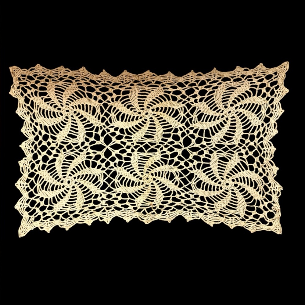 Vintage doily with pinwheel design. 16 x 10” Some spots